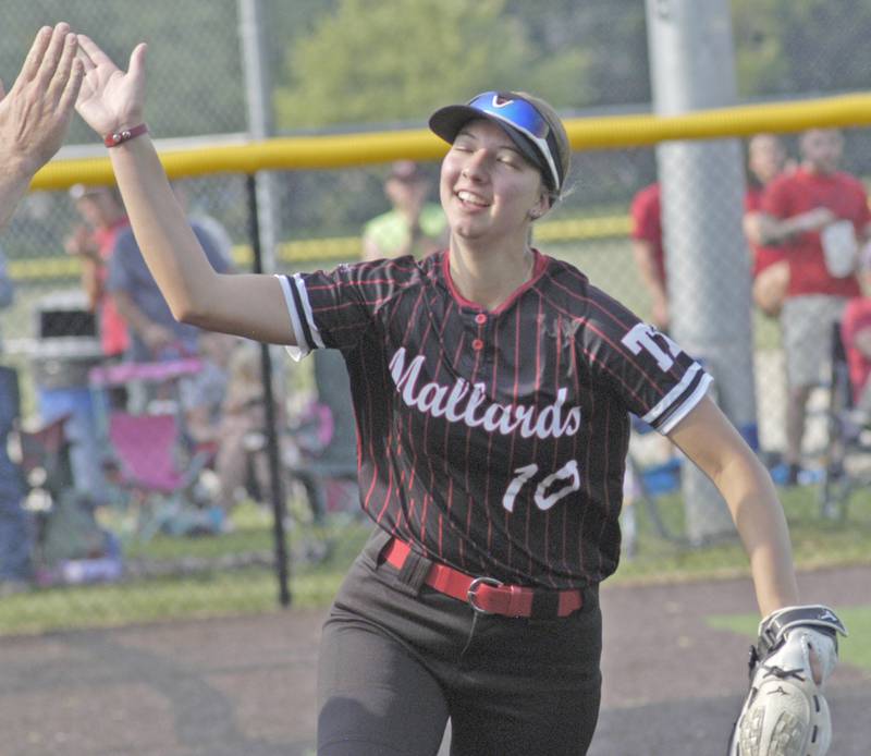 Mallard left fielder Rachel Eckert high fives a fan after a catch. Dakota and Henry-Senachwine softball met in  Illinois  Class 1A Super Sectional in Sterling on June 2, 2025. Dakota won the contest 2-0.