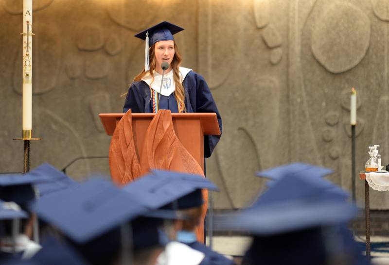 Executive Council member of Nazareth High School, Olivia Schaff  greets the class of 2022 and staff members with "Thank You" during their graduation Sunday May 22, 2022.