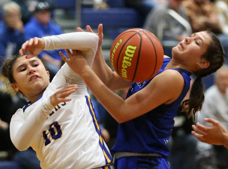 Aurora Central Catholic's Anna Marie Godina looses control of the ball as Newark's Brooklyn Hatteberg lets it go out of bounce in the Tim Humes Breakout Tournament on Friday, Nov. 18, 2022 in Somonauk.