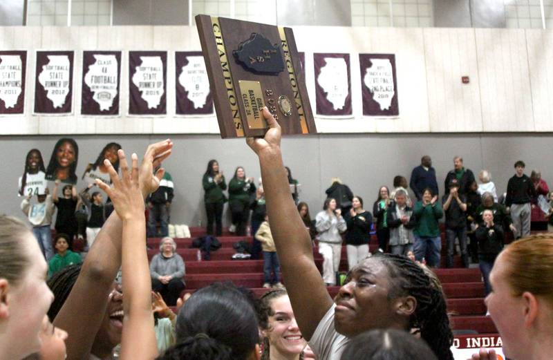 St. Edwards’ Sanaii McPherson reacts after receiving the title hardware in IHSA Regional Championship girls basketball on Thursday, Feb. 19, 2026, at Marengo High School in Marengo.