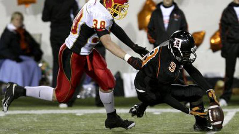 Batavia’s Ryan Welter chases DeKalb’s Damian Nelson after a failed lateral pass. Batavia recovered the ball giving it excellent field position which then led to Batavia’s first touchdown. The Bulldogs defeated the Barbs 53-14. Rob Winner | Chronicle News Group