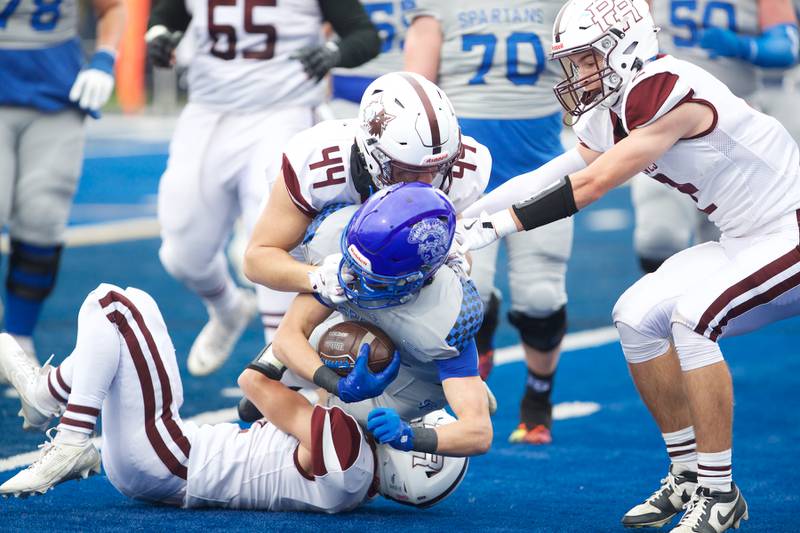 Prarie Ridges Jace Kranig tackles St Francis Hunter Eberle at the Class 5A second-round playoff game on Saturday Nov.9,2024 in Wheaton.
