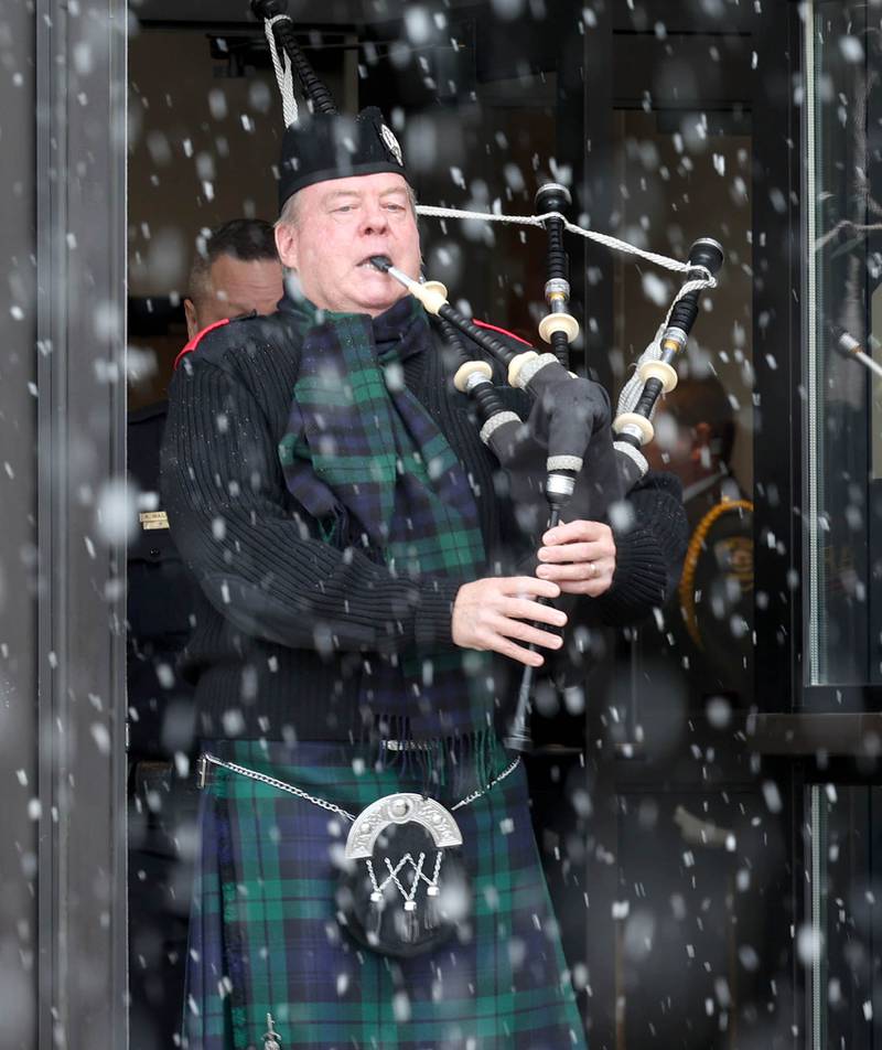 A bagpipe player leads the casket of former DeKalb County Sheriff Roger Scott out of the church Friday, March 7, 2025, following his memorial service at Bethany Road Bible Church in DeKalb. Scott, who was the county sheriff for 36 years, died on February 23 at the age of 78.