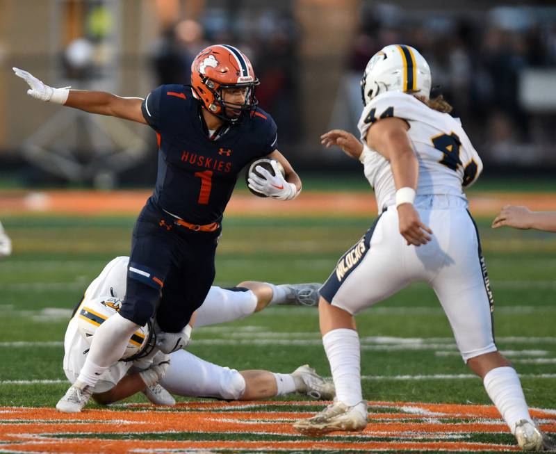 Joe Lewnard/jlewnard@dailyherald.com
Naperville North’s Cole Arl gets tackled by Neuqua Valley’s Justin Dutkiewicz, lower left, during Friday’s game in Naperville.