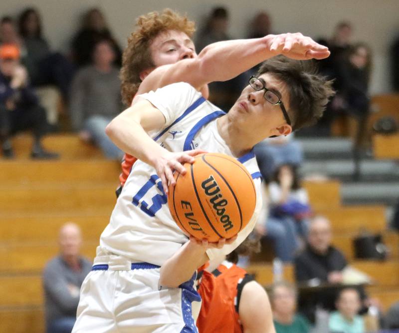 Woodstock’s Joseph Nitz, front, is guarded by Sandwich’s Dom Rome in varsity boys basketball on Tuesday, Feb. 11, 2025, at  Woodstock High School in Woodstock.
