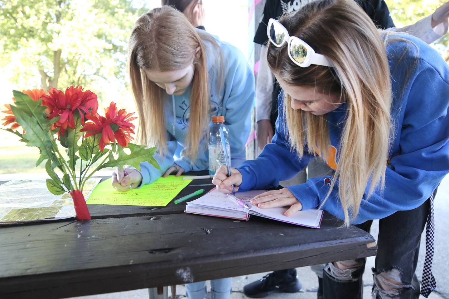 Attendees sign a guest book and a petition for Gracie’s Law asking for harsher penalties for sex offenders Thursday, Sept. 14, 2023, at the Sycamore Community Sports Complex during a celebration of the life of Gracie Sasso-Cleveland on what would have been her sweet 16 birthday. Sasso-Cleveland, 15, was found dead May 7, 2023, in DeKalb. Timothy M. Doll, 29, of DeKalb, is charged with first-degree murder in her death.
