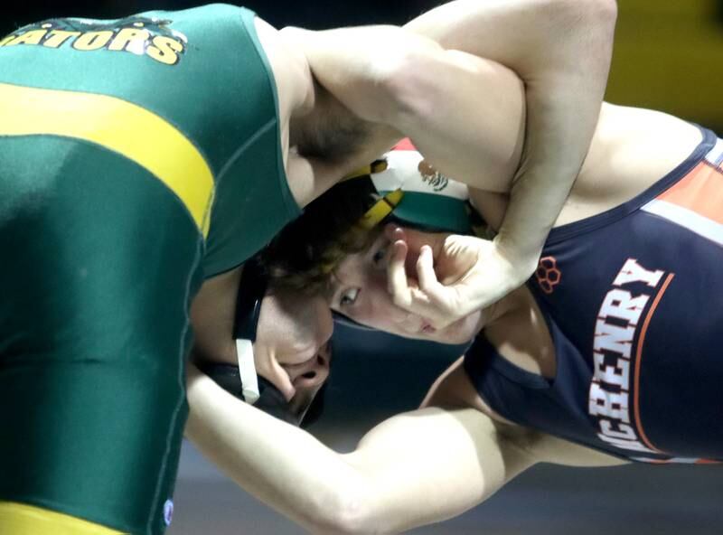 Crystal Lake South’s Leroy Flores, left, battles McHenry’s Pedro Jimenez in a 126-pound match during varsity wrestling at Crystal Lake Thursday night.