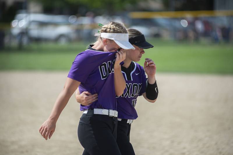 Dixon’s Sam Tourtillott (left) and Ana Kate Phillips walk off the field following a walk off win for Sterling Saturday, May 28, 2022.