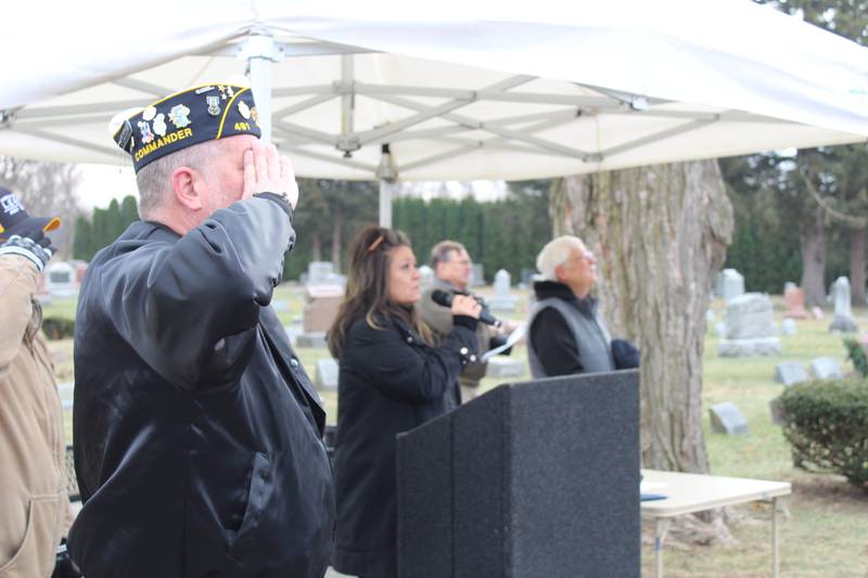 A veteran salutes during the National Anthem at Union Cemetery in Crystal Lake on Dec. 14, 2024, during the Wreaths Across America ceremony.