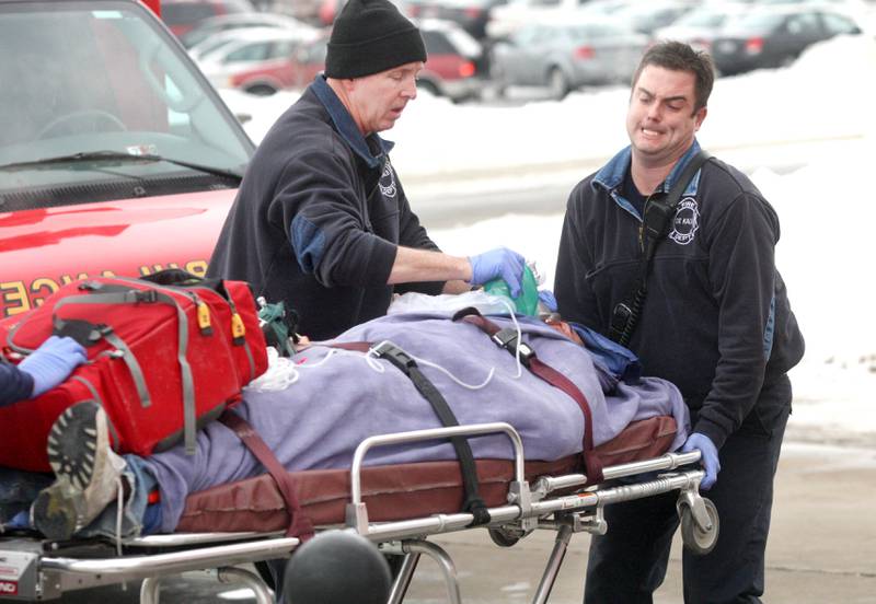 Shaw Local 2008 file photo – Paramedics, including DeKalb firefighter/paramedic Patrick Eriksen (right) rush a victim to a waiting ambulance following a shooting rampage that left six people, including the gunman, dead, and injured dozens more at Northern Illinois University in DeKalb on Thursday, Feb. 14, 2008.