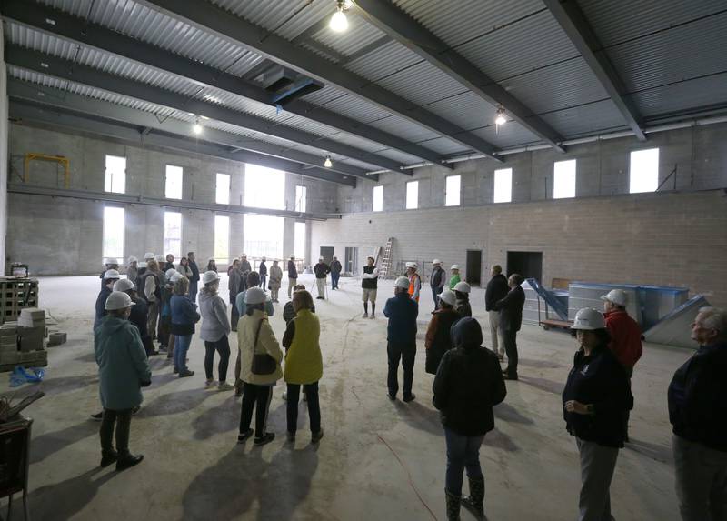 A large group of people tour the gymnasium area inside the new YMCA building on Thursday, Oct., 19, 2023 in Ottawa.
