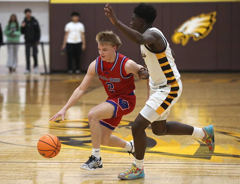 Dundee-Crown's Shane Demarsh tries to drive against Jacobs' Samson Averehi during a Fox Valley Conference boys basketball game on Tuesday, February. 3, 2026, at Jacobs High School in Algonquin.