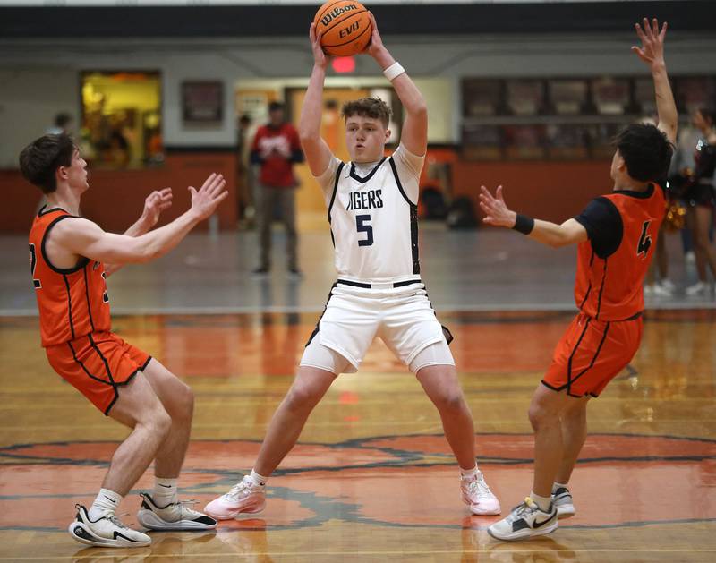 Crystal Lake Central's JR Mason looks to pass as he is guarded by McHenry's Blake Renfro (left) and Cole Tapia (right) during a Fox Valley Conference boys basketball game on Tuesday, February. 10, 2026, at Crystal Lake Central High School.