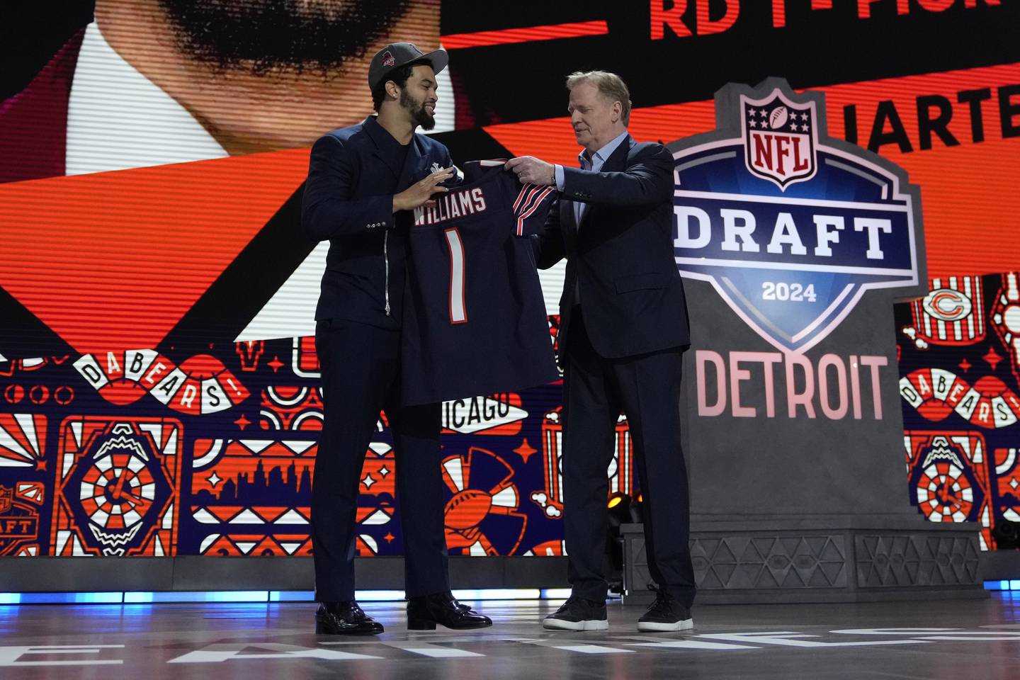 Southern California quarterback Caleb Williams celebrates with NFL commissioner Roger Goodell after being chosen by the Chicago Bears with the first overall pick during the first round of the NFL football draft, Thursday, April 25, 2024, in Detroit. (AP Photo/Jeff Roberson)