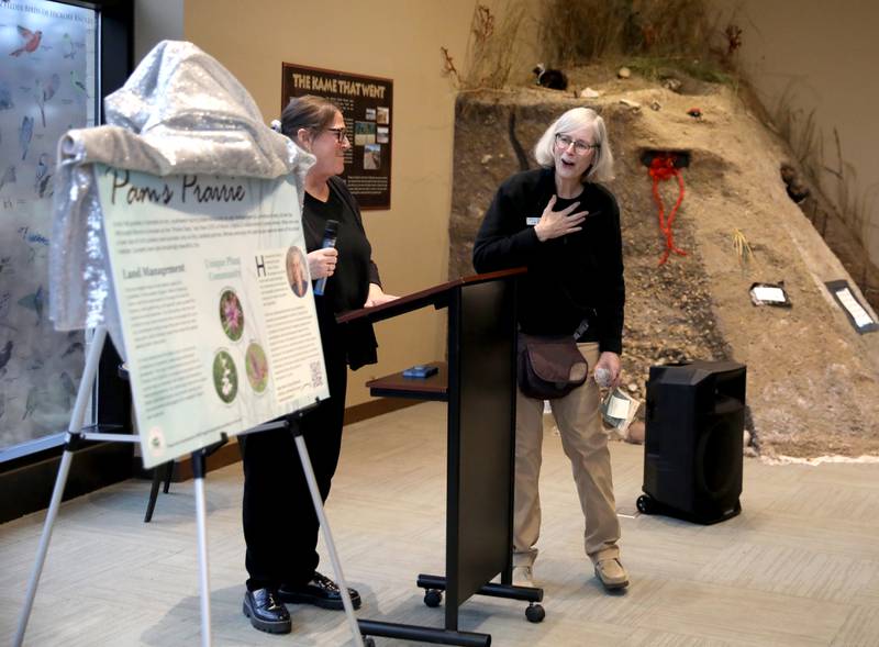 Pam Otto, a naturalist and outreach ambassador at the St. Charles Park District, reacts to an area of the district being renames Pam’s Prairie with Director of Parks and Recreation Holly Cabel during a retirement party in her honor on Tuesday, Dec. 17, 2024 at the Hickory Knolls Discovery Center in St. Charles.