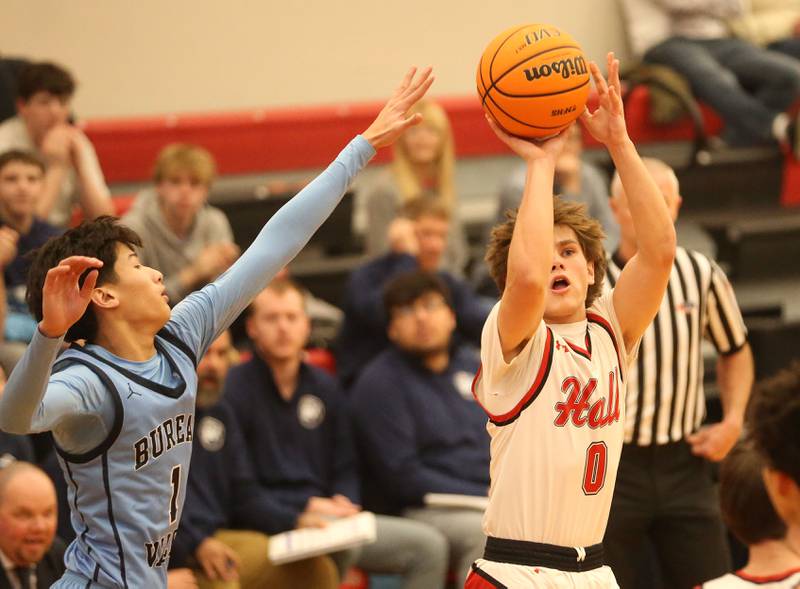 Hall's Greyson Bickett lets go of a shot over Bureau Valley's CArter Chhim on Wednesday, Jan. 28, 2026 at Hall High School.