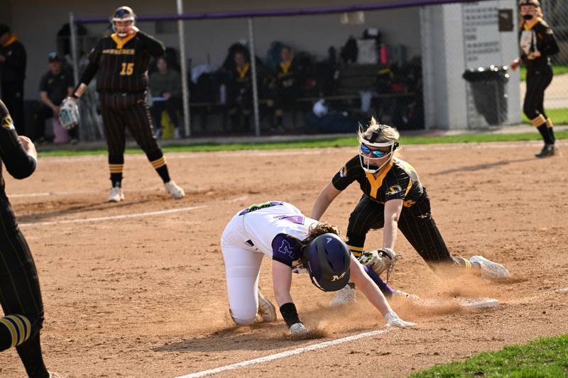 Herscher's Addy Whitaker dives to put the tag on Manteno's Julie Ott during the Tigers' 4-1 loss to Manteno on Monday, May 5, 2025.