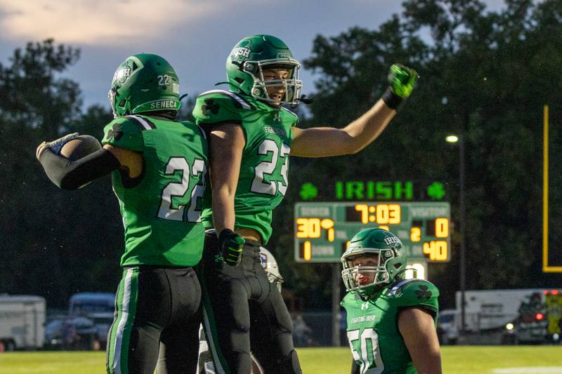 (from left) Brady Sheedy (23)  of Seneca celebrates touchdown with teammate Cameron Shriey (33) on Friday, Aug 29, 2025 at Seneca High School in Seneca.
