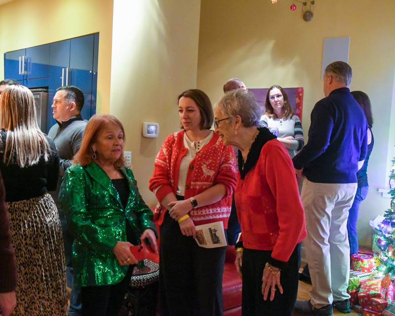 Katherine Padgett,left, president of the Historic society talks with Molly Vimont, center, of Brookfield and her grandmother Ellie Carroll of La Grange Park during the Holiday Sip and Sweet Tour event held in La Grange on Sunday Dec. 17, 2023.