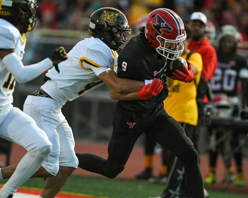 Yorkville's AJ DiVito (9) runs the ball for some yards before getting pushed out of bounds by Joliet West's Dante Farrell during the game on Friday Sept. 5, 2025,  held at Yorkville High School.