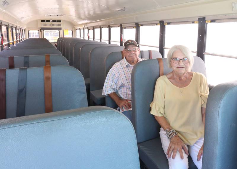 Authur and Linda Simpson pose inside a school bus on Monday, July 28, 2025 at the Streator-Woodland Bus Company. The Simpsons have a combined 101-years of driving a school bus.
