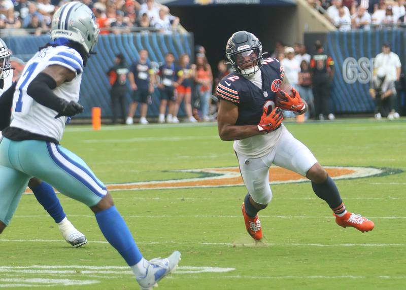 Chicago Bears wide receiver DJ Moore runs with the ball as Dallas Cowboy's corner back Trevon Diggs eyes the play on Sunday, Sept. 21, 2025 at Soldier Field.