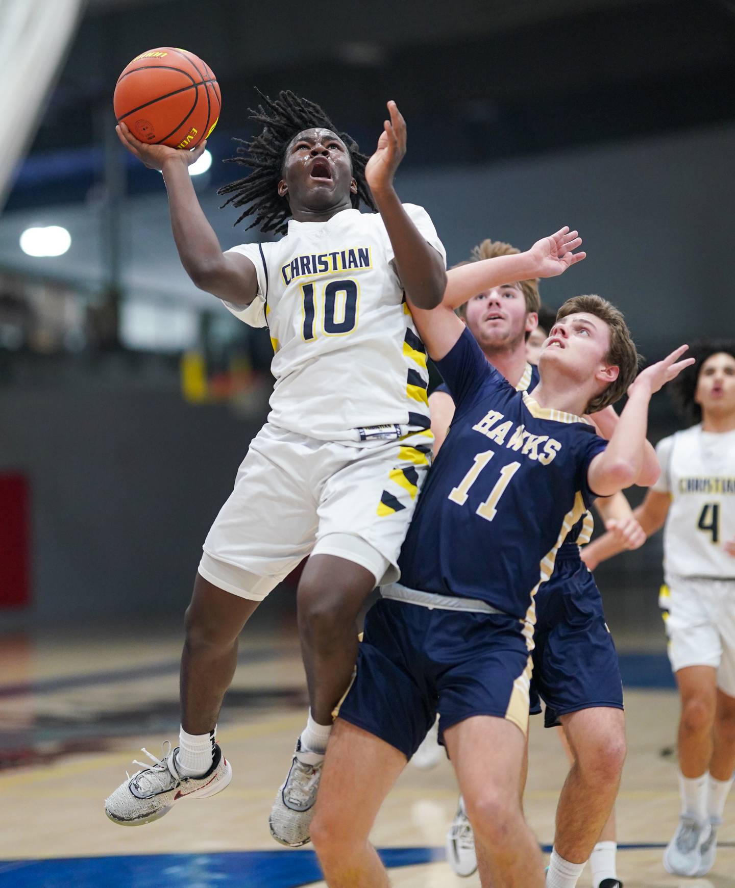 Yorkville Christian's Jayden Riley (10) drives to the hoop against Hiawatha's Thomas Giebel (11) during a basketball game at Yorkville Christian High School in Yorkville on Friday, Jan 5, 2024.