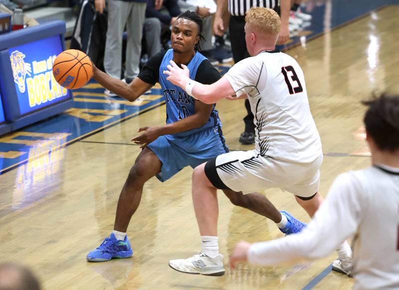 IMSA’s Benjamin Dixson passes the ball around Indian Creek's Isaac Willis Friday, Feb. 6, 2026, during their Little 10 Conference championship game at Somonauk High School.