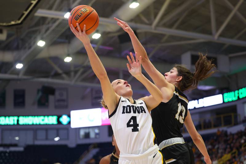 Iowa Hawkeyes guard Kylie Feuerbach (4) shoots a layup over an Indiana-Purdue-Fort Wayne defender during the first quarter of their game at Hertz Arena in Estero, Florida on Friday, November 24, 2023. (Stephen Mally/hawkeyesports.com)