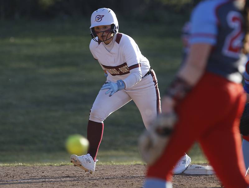Richmond-Burton’s Sydney Hird looks to go home as Marian Central’s Christine Chmiel throws a pitch during a nonconference softball game Tuesday, March 19, 2024, at Richmond-Burton High School.