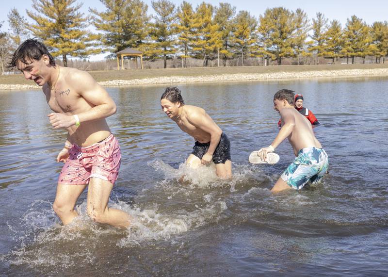 Participants run out of Lake Mendota during the 2024 Special Olympics Polar Plunge on February 24, 2024.