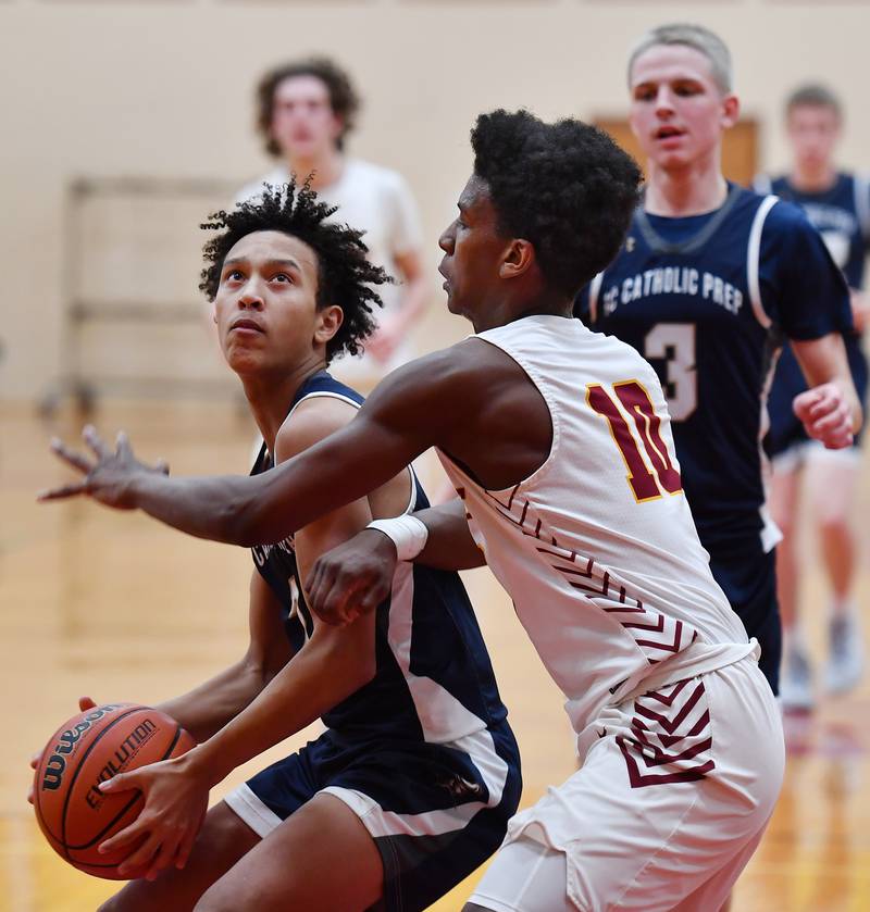 IC Catholic's Jordan Hall looks to the hoop as Westmont's Malachi Boatright (10) sefends during a game on Jan. 5, 2024 at Westmont High School in Westmont.