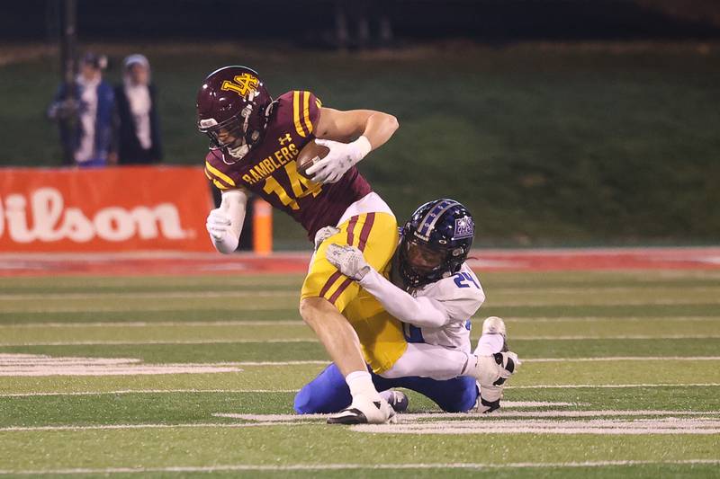 Loyola’s William Carlson is brought down by Lincoln-Way East’s Dylan Weathers after a first down catch in the Class 8A championship on Saturday, Nov. 25, 2023 at Hancock Stadium in Normal.
