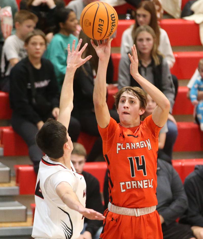 Flanagan-Cornell's Seth Jones shoots a jump shot over Woodland's Nick Plesko during the Route 17 Classic Tournament on Wednesday, Nov. 27, 2024 at Woodland High School.