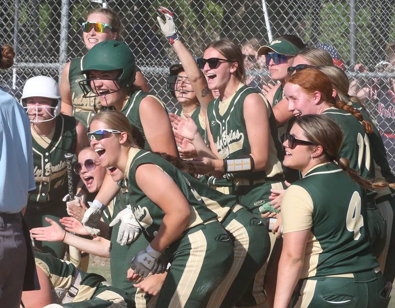 Members of the St. Bede softball team react behind after teammate Ella Hermes hit a three-run home run against Biggsville in the Class 3A Sectional championship game on Friday, May 26, 2023 at St. Bede Academy.