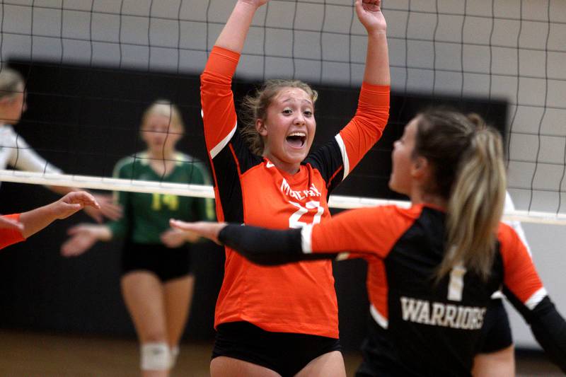 McHenry’s Riley Ten Bruin and the Warriors celebrate a point against Crystal Lake South in varsity volleyball at McHenry Tuesday night.