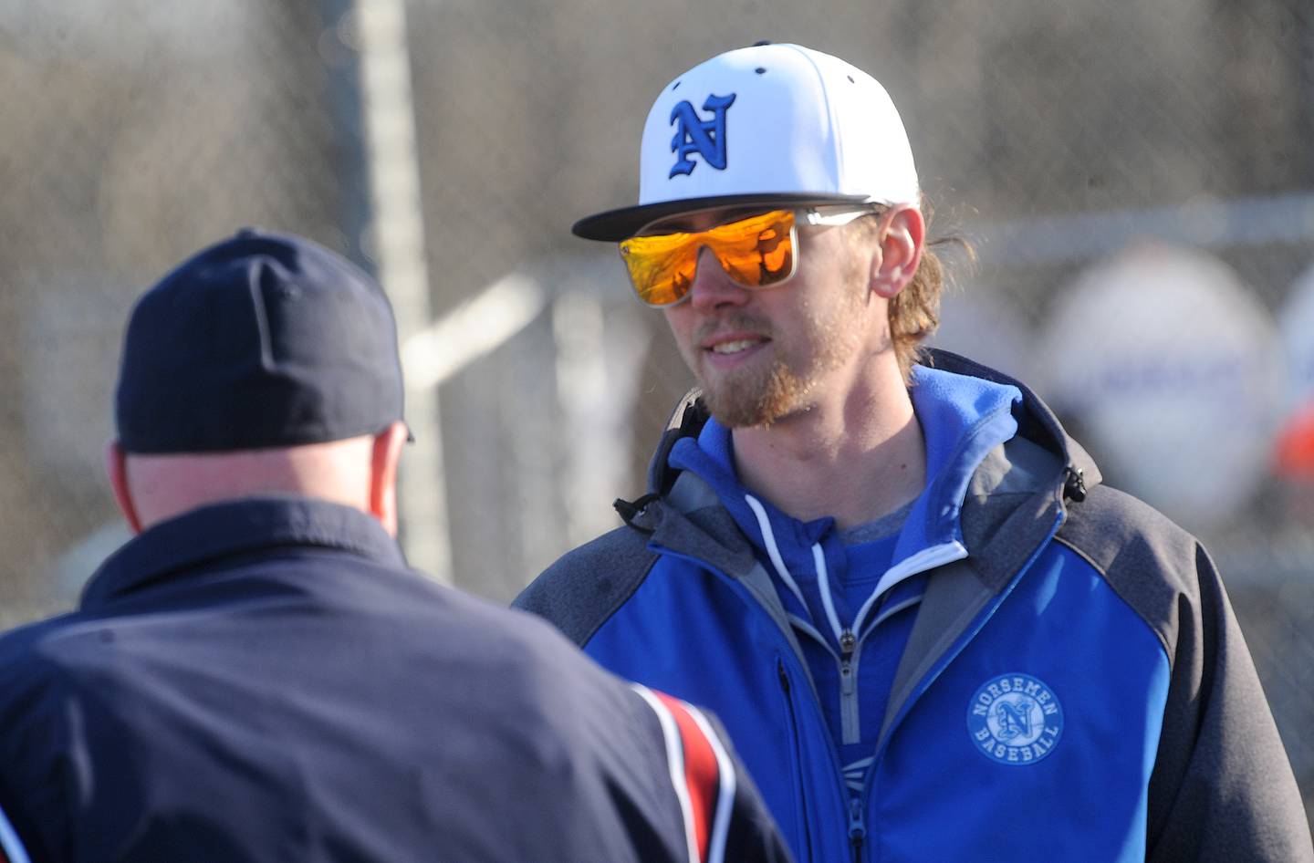 Newark head baseball coach Josh Cooper talks with the umpire during a varsity baseball game against Morris at Newark High School on Wednesday, Mar. 29, 2023.