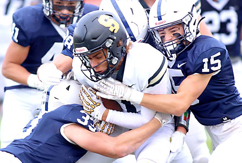 Cary-Grove’s Jason Ritter, Jr., right, wraps up Sycamore’sJosiah Mitchell in IHSA football Class 5A first-round playoff action at Al Bohrer Field on the campus of Cary-Grove High School in Cary on Saturday, November 1, 2025.