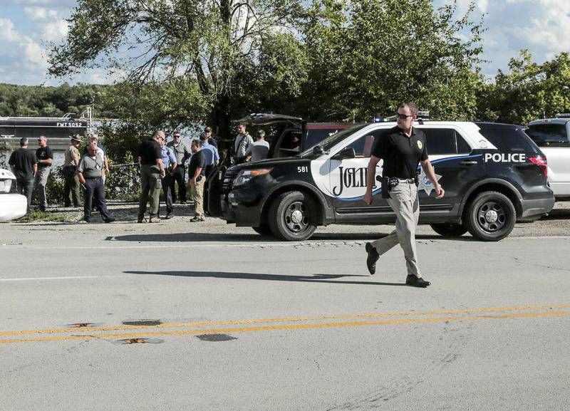 State and local investigators secure a scene along Route 6 on Aug. 27 where the body of Lesly Reynoso was discovered in the Des Plaines River in Joliet.