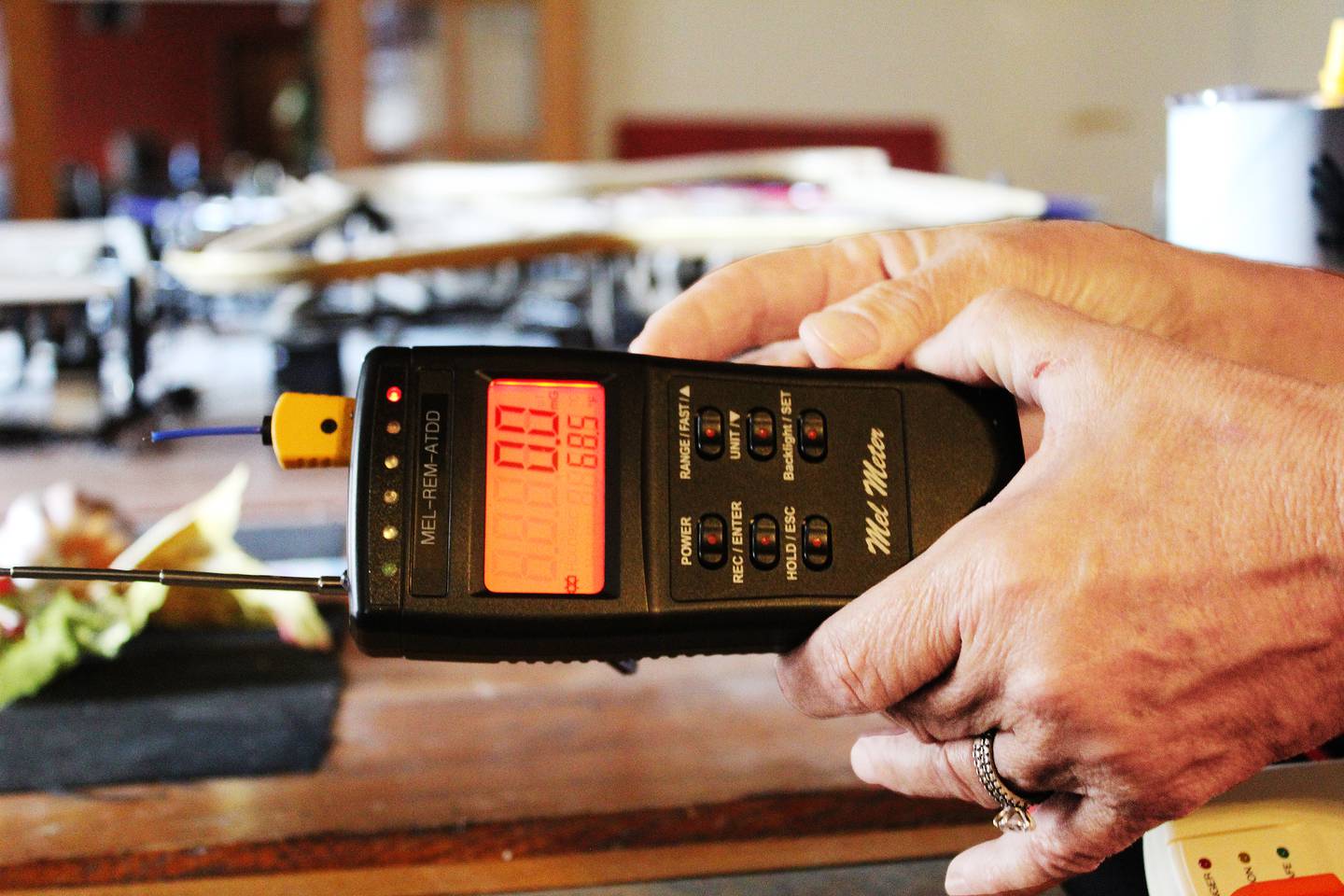 A Mel meter is a handheld electronic device used in paranormal investigations to detect fluctuations in electromagnetic fields and ambient temperature, which are believed to be indicators of spirit presence.