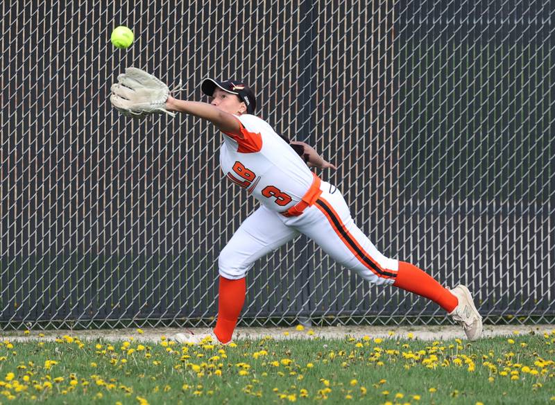 DeKalb's Emma Hart makes a diving catch Friday, May 2, 2025, during their game against Sycamore at DeKalb High School.