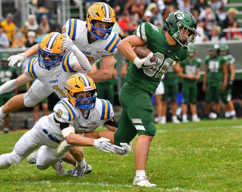 Glenbard West wide receiver Brian Clohecy (88) looks to escape three Lyons Township tacklers during a game on Sep. 16, 2023 at Glenbard West High School in Glen Ellyn.