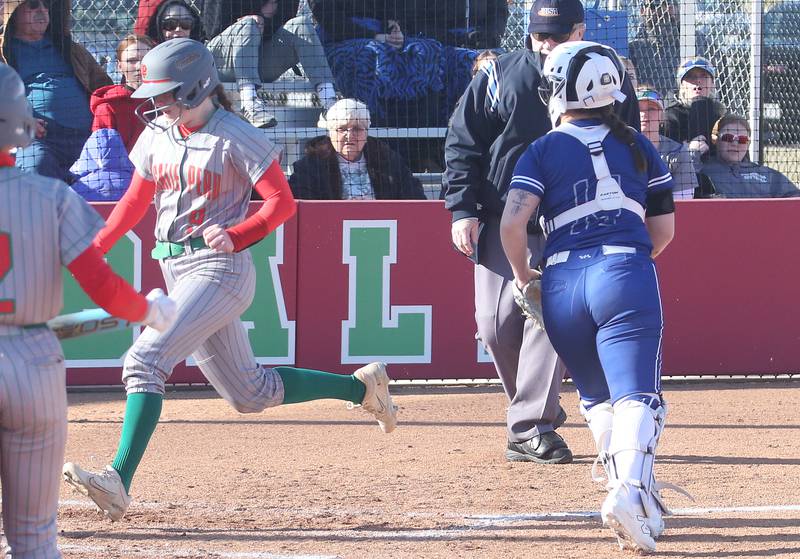 L-P's Allie Thome crosses home plate as a late throw goes over the head of Princeton catcher Izzy Gibson on Tuesday, March 25, 2025 at the L-P Athletic Complex in La Salle.