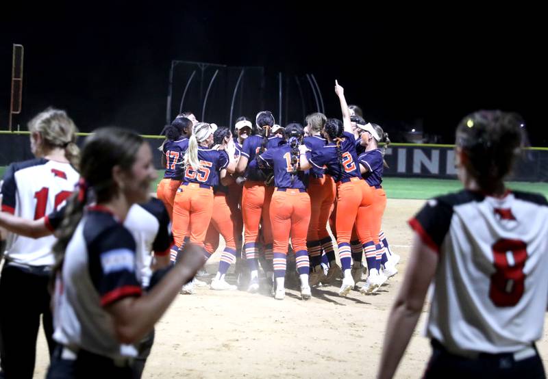 Oswego players celebrate their Class 4A Benedictine Supersectional win over Marist on Monday, June 9, 2025 in Lisle.