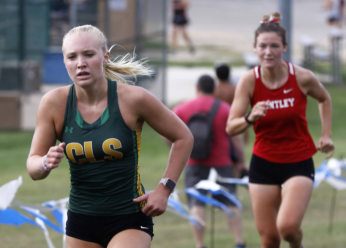 Crystal Lake South’s Abby Machesky runs to the finish line in front of Huntley’s Ava Allison during the girls race of the McHenry County Cross Country Meet Saturday, August 27, 2022, at Emricson Park in Woodstock.