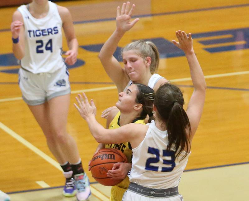 Putnam County's Ava Hatton sneaks through the lane between Princeton's Reese Reviglio and teammate Miyah Fox during the Princeton High School Lady Tigers Holiday Tournament on Thursday, Nov. 16, 2023 at Prouty Gym.