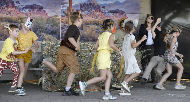 Children actors perform the stampede scene where King Mufasa is killed during "Lion King Jr." on Friday, Aug. 11, 2023, at Knudson Park in Marseilles.