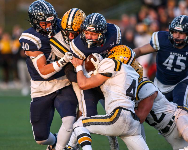 IC Catholic Prep's Joey Gliatta (33) is gang tackled by the St Laurence defense during Class 4A third round playoff football game between St Laurence at IC Catholic Prep.  Nov 11, 2023.