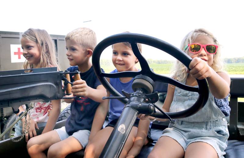 Ellie Giuliano, (L-R) 7, Asher Anderson, 5, Emma Anderson, 6, and Vivian Giuliano, 5, check out a World War I era Ford vehicle during the Sycamore Steam Show Thursday, Aug. 10, 2023, at Taylor Marshall Farm in Sycamore. The show runs from 7 a.m. to 5 p.m. through Sunday.