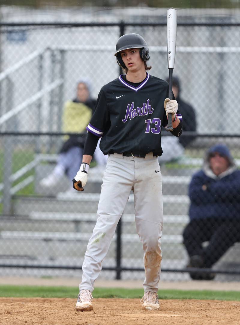 Downers Grove North's Jude Warwick (13) looks down to the third base coach during the varsity baseball game between Downers Grove South and Downers Grove North in Downers Grove on Saturday, April 29, 2023.